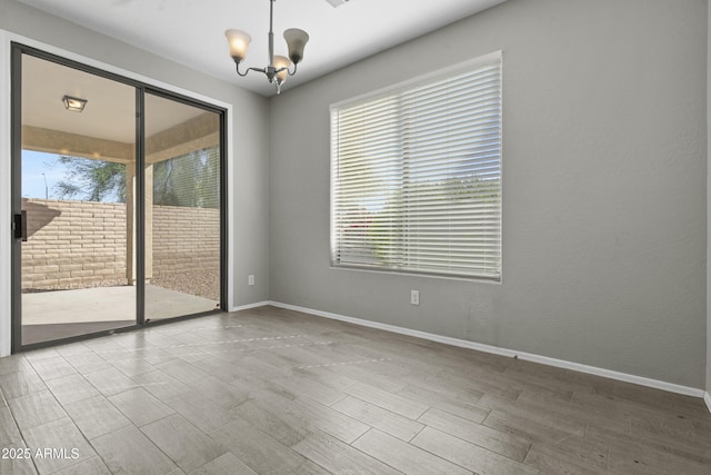 29302 N 126th Ln, Peoria, AZ 85383 - spare room with a chandelier, baseboards, and wood finished floors