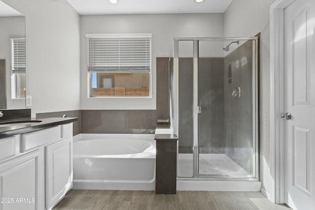 29302 N 126th Ln, Peoria, AZ 85383 - bathroom with vanity, a bath, a stall shower, wood finished floors, and recessed lighting
