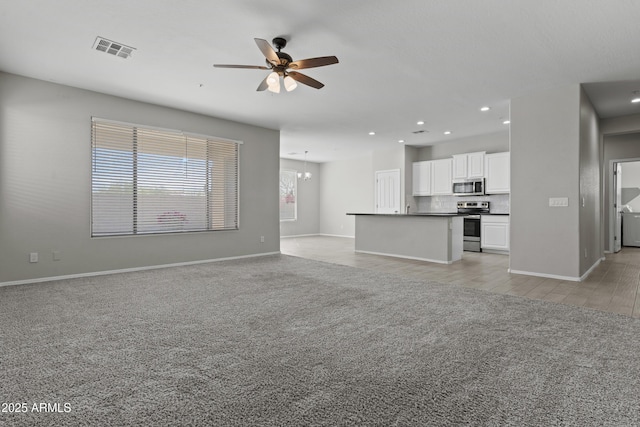 29302 N 126th Ln, Peoria, AZ 85383 - unfurnished living room featuring light colored carpet, ceiling fan, baseboards, recessed lighting, and a chandelier