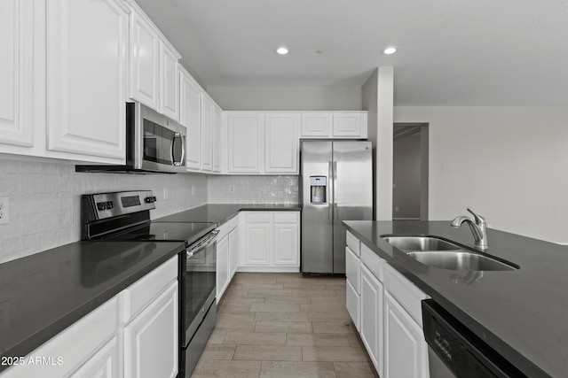 29302 N 126th Ln, Peoria, AZ 85383 - kitchen with appliances with stainless steel finishes, a sink, dark countertops, white cabinetry, and decorative backsplash