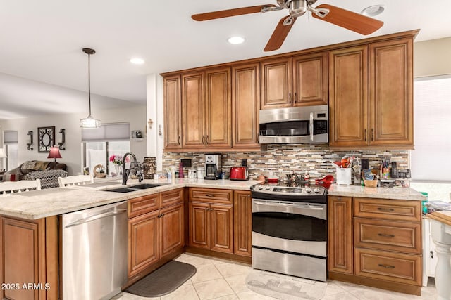 19822 N 108th Ave, Peoria, AZ 85373 - kitchen with stainless steel appliances, a sink, brown cabinetry, a ceiling fan, and recessed lighting