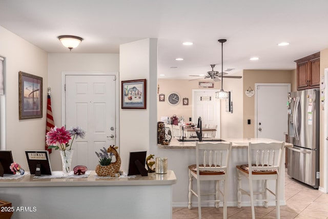 19822 N 108th Ave, Peoria, AZ 85373 - kitchen featuring stainless steel fridge with ice dispenser, a sink, a kitchen breakfast bar, a peninsula, and a ceiling fan