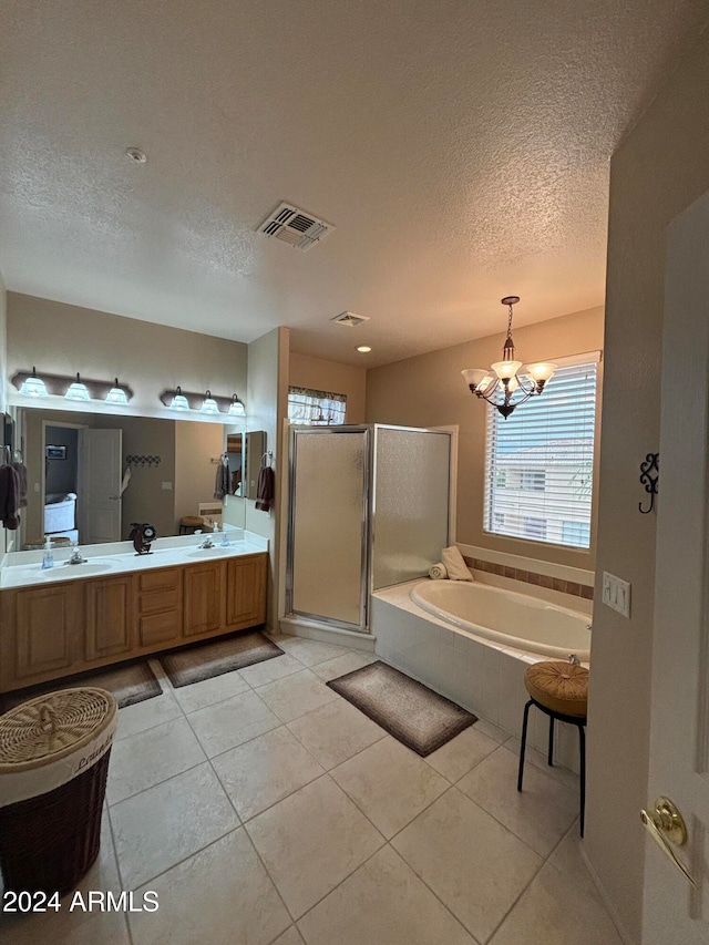 bathroom with tile patterned floors, a textured ceiling, plus walk in shower, and an inviting chandelier