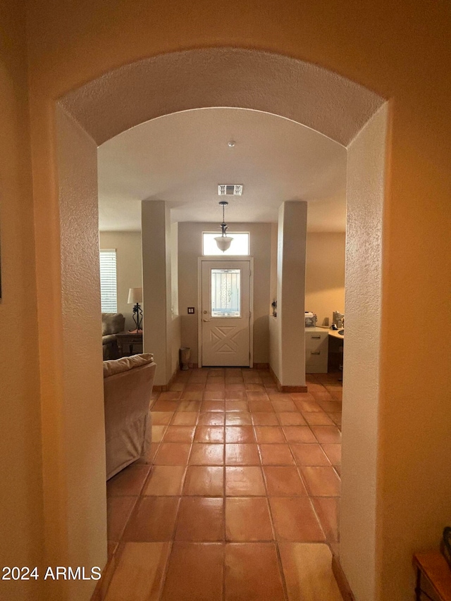 entryway with light tile patterned floors