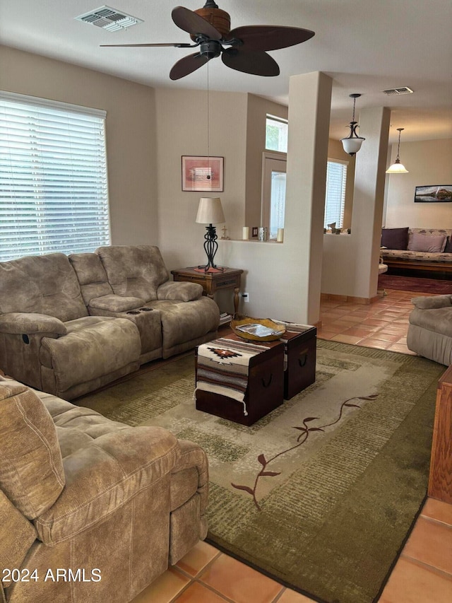 tiled living room with ceiling fan