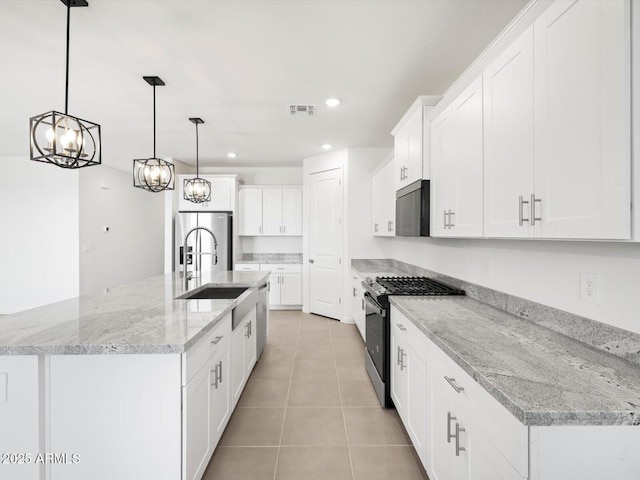 kitchen with visible vents, recessed lighting, white cabinetry, a sink, and stainless steel appliances