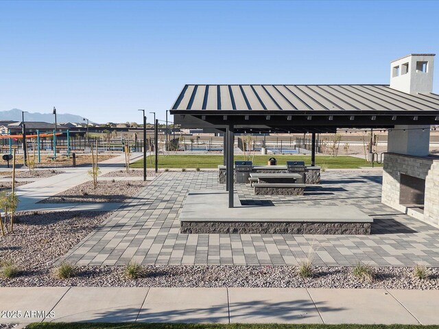 surrounding community featuring fence, a mountain view, and a gazebo
