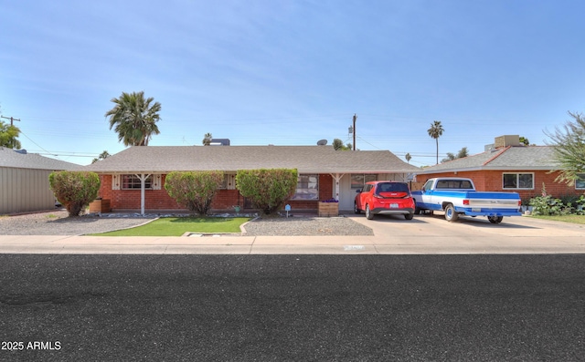 ranch-style home with concrete driveway