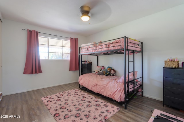 bedroom with baseboards, wood finished floors, and ceiling fan