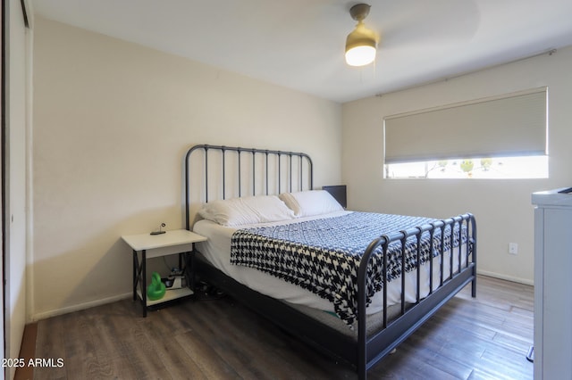 bedroom featuring baseboards, ceiling fan, and wood finished floors