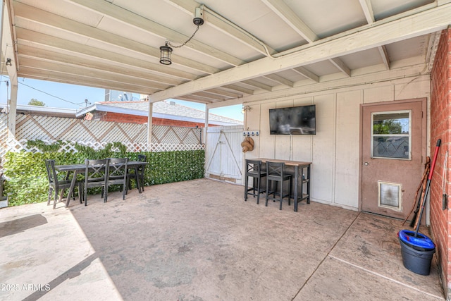 view of patio with fence and outdoor dining space