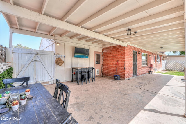 view of patio / terrace featuring a gate and fence