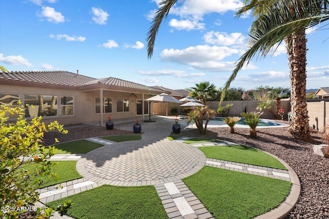 view of yard featuring a patio and a fenced in pool