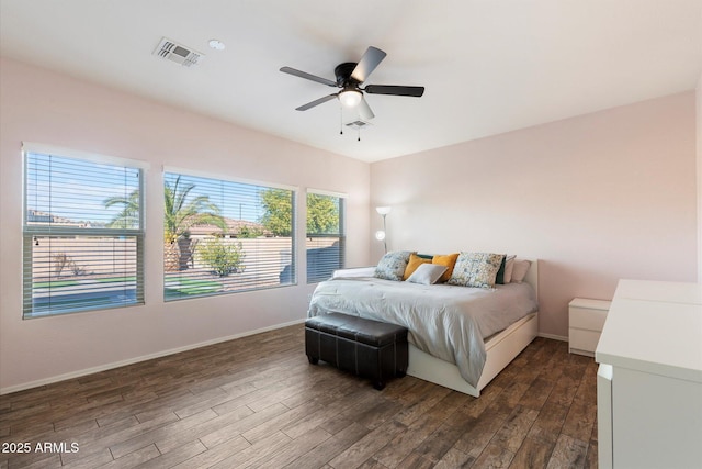 bedroom with ceiling fan and dark hardwood / wood-style floors