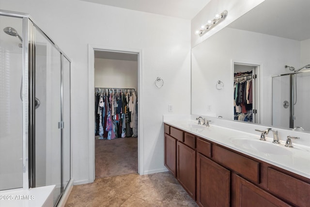 bathroom featuring vanity and an enclosed shower