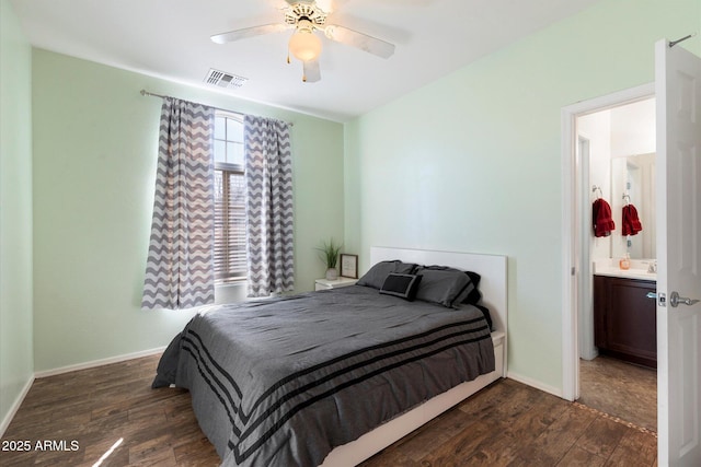 bedroom with ensuite bathroom, ceiling fan, dark wood-type flooring, and sink