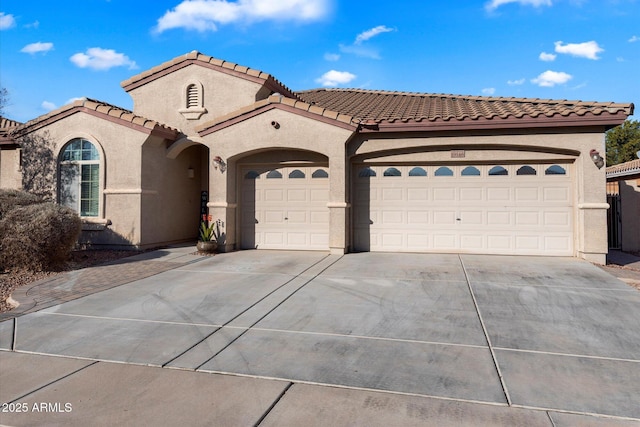 mediterranean / spanish-style home with a garage