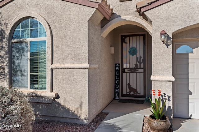 view of exterior entry featuring a garage