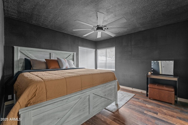 bedroom with baseboards, wood finished floors, and a ceiling fan