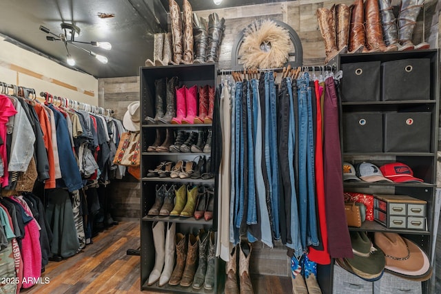 walk in closet with wood finished floors