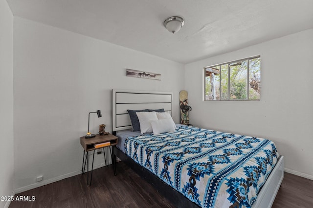 bedroom featuring baseboards and wood finished floors