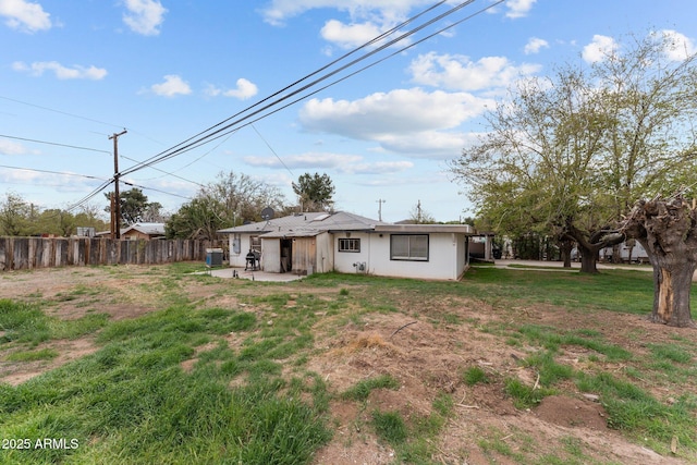 back of house featuring a patio and fence
