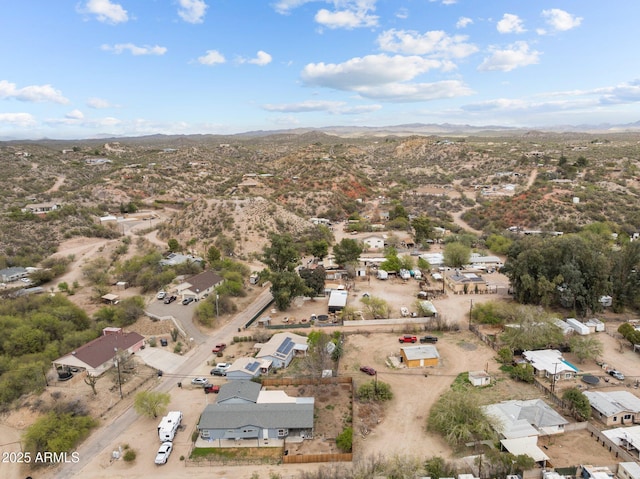 birds eye view of property featuring a mountain view and view of desert