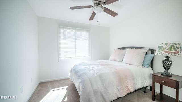 carpeted bedroom with ceiling fan and baseboards