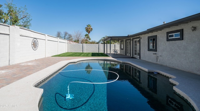 view of swimming pool with a patio, a fenced backyard, and a fenced in pool