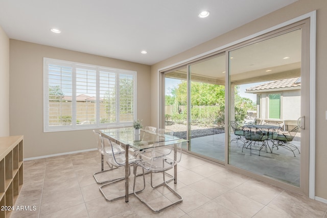 tiled dining space featuring plenty of natural light