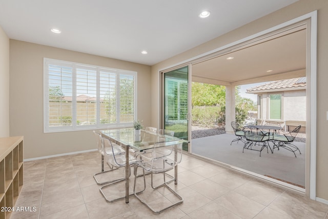 tiled dining room with a healthy amount of sunlight