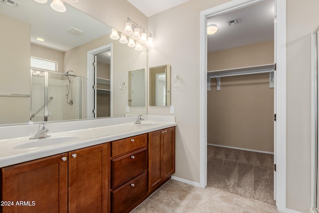 bathroom with vanity, tile patterned flooring, and walk in shower