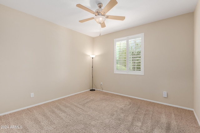 spare room featuring ceiling fan and carpet