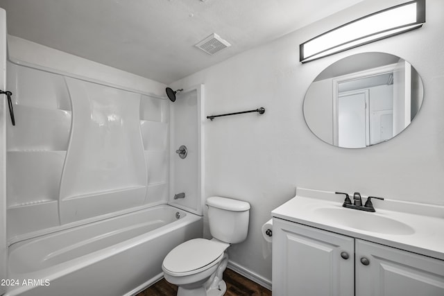 bathroom with toilet, wood finished floors, vanity, visible vents, and washtub / shower combination