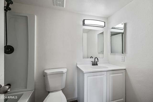 bathroom featuring toilet, a textured wall, visible vents, and vanity