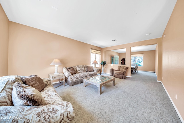 living room with a healthy amount of sunlight and carpet flooring