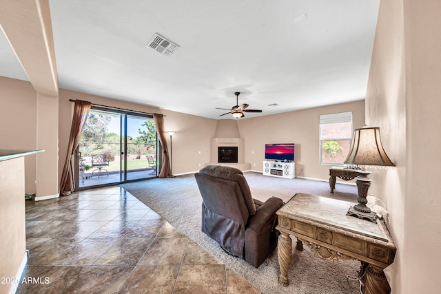 carpeted living room featuring ceiling fan