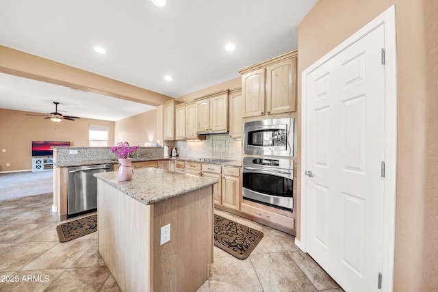 kitchen with appliances with stainless steel finishes, light brown cabinetry, tasteful backsplash, kitchen peninsula, and light stone countertops