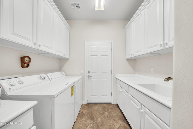 laundry room with cabinets, washing machine and dryer, sink, and light tile patterned flooring