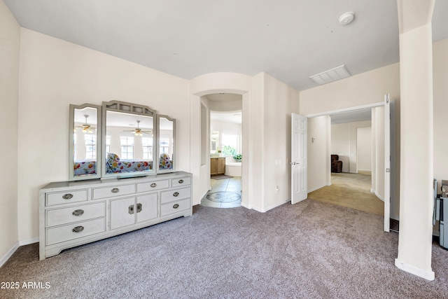 unfurnished bedroom with ensuite bath and light carpet