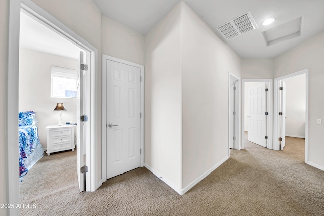 corridor with light colored carpet