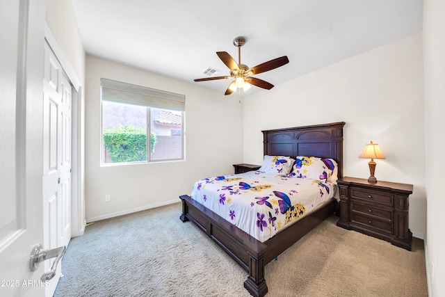 bedroom featuring light colored carpet, a closet, and ceiling fan