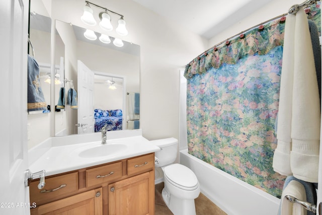 full bathroom featuring shower / tub combo with curtain, tile patterned floors, toilet, vanity, and ceiling fan