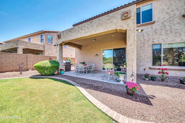 back of property featuring a yard and a patio area