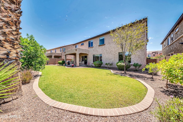 back of house featuring a yard and a patio area