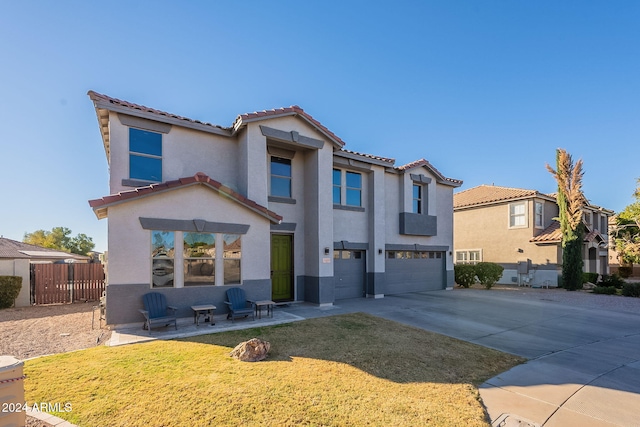 mediterranean / spanish home with a front lawn and a garage