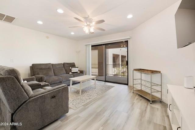 living room featuring light wood-type flooring and ceiling fan