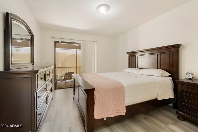 bedroom with light hardwood / wood-style floors and multiple windows