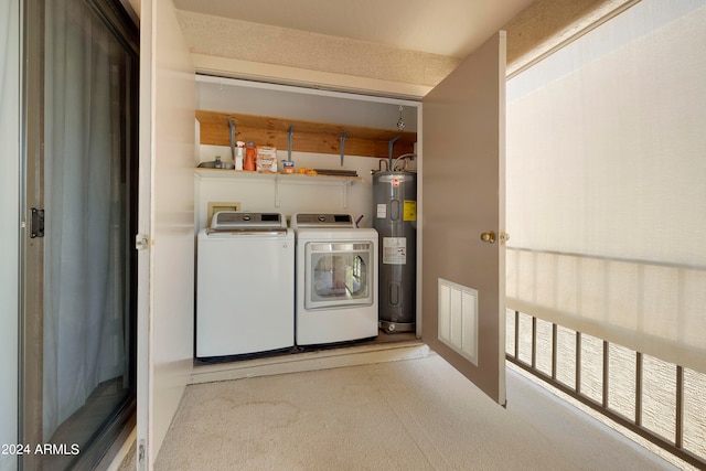 laundry room with separate washer and dryer, electric water heater, and light colored carpet