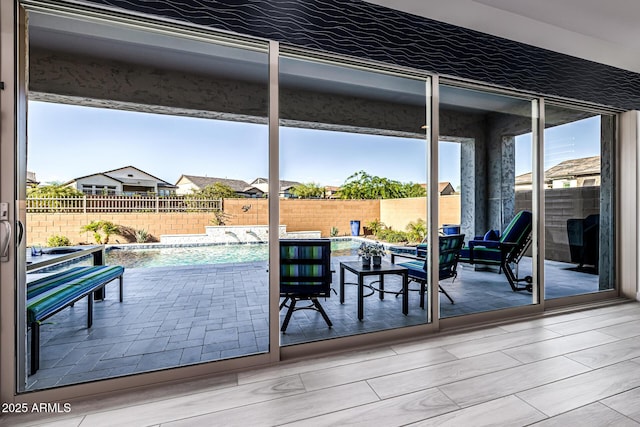 doorway featuring healthy amount of natural light and floor to ceiling windows